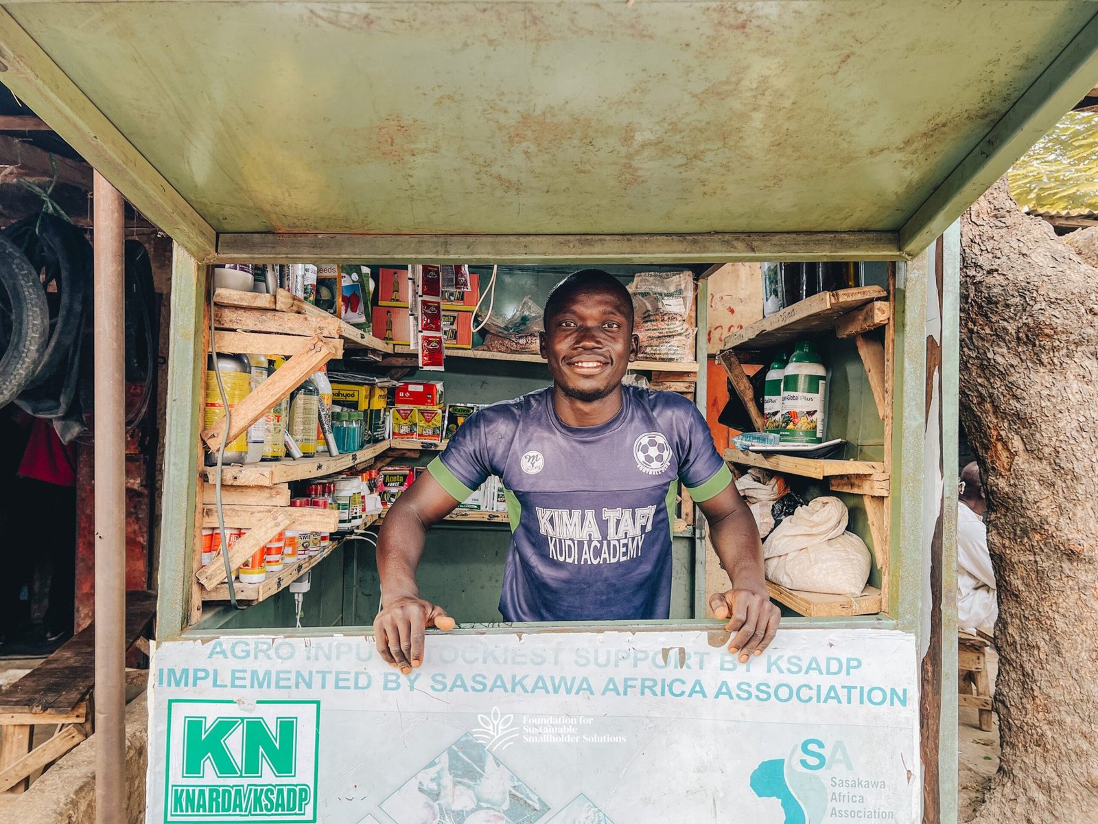 Talatu's youngest son manning her input store at Bunkure market