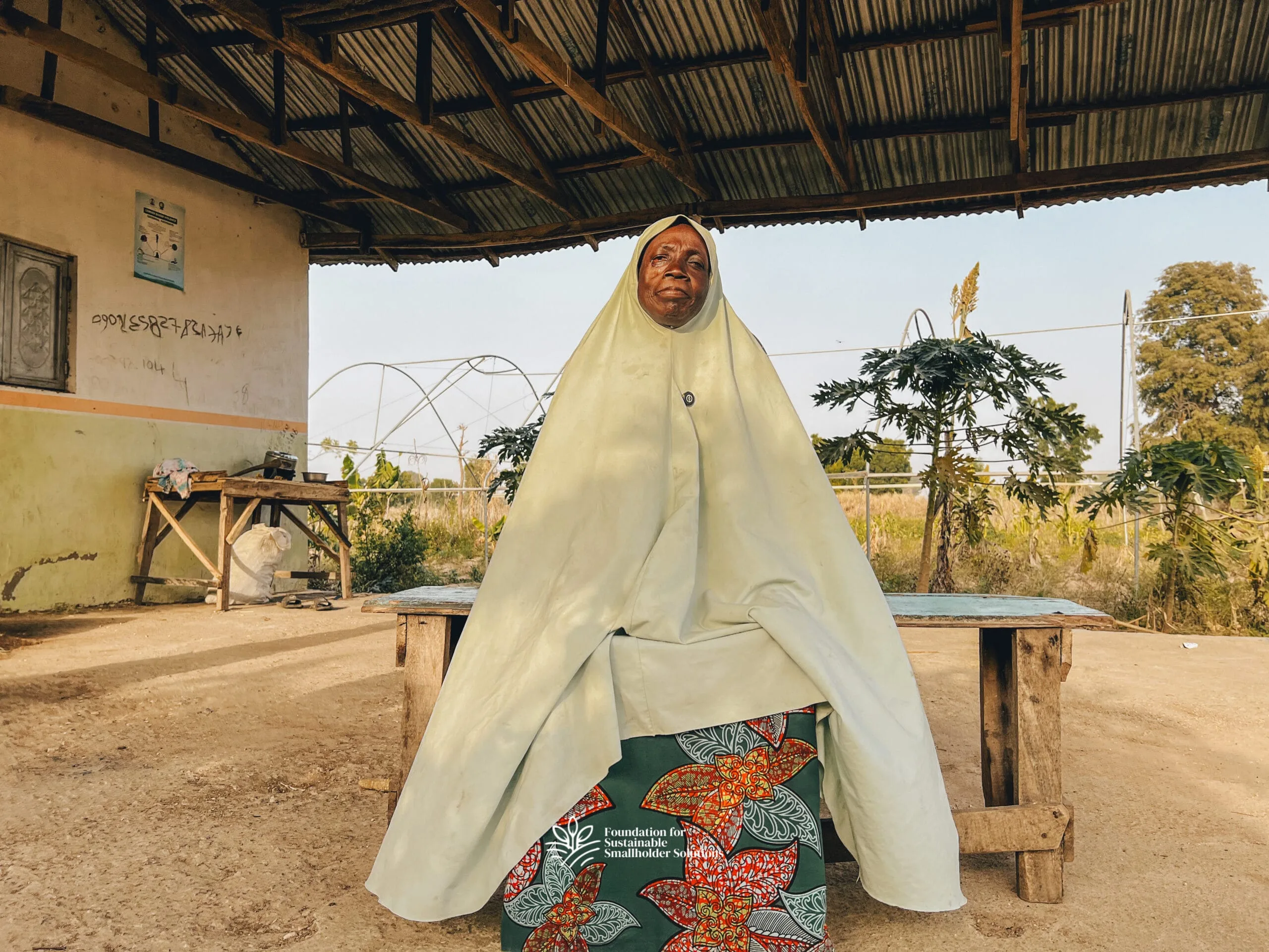 Talatu Idris sitting outside in front of the Farmers' Hub building 