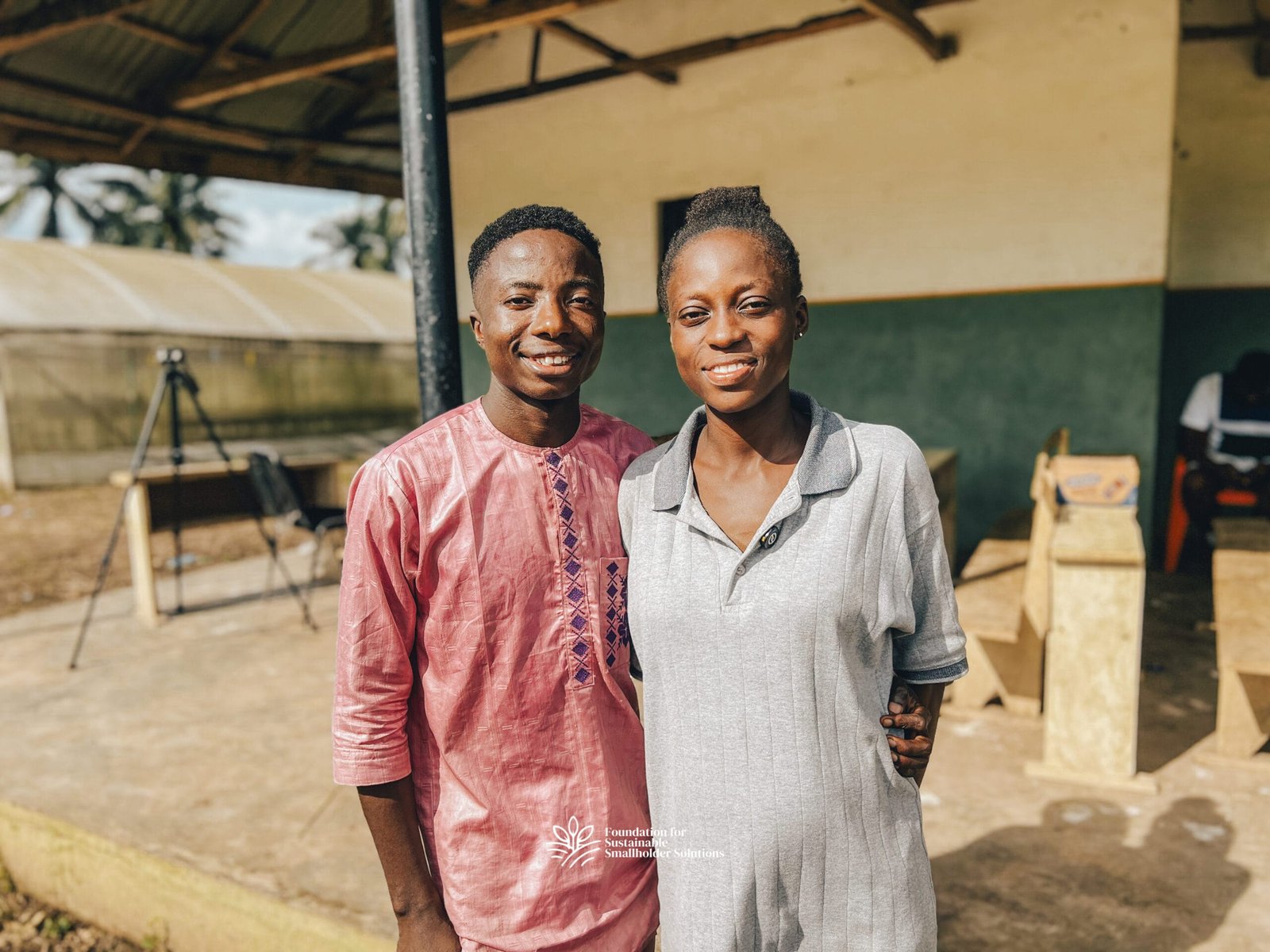 Ajibola standing next to his wife, Tinuola.