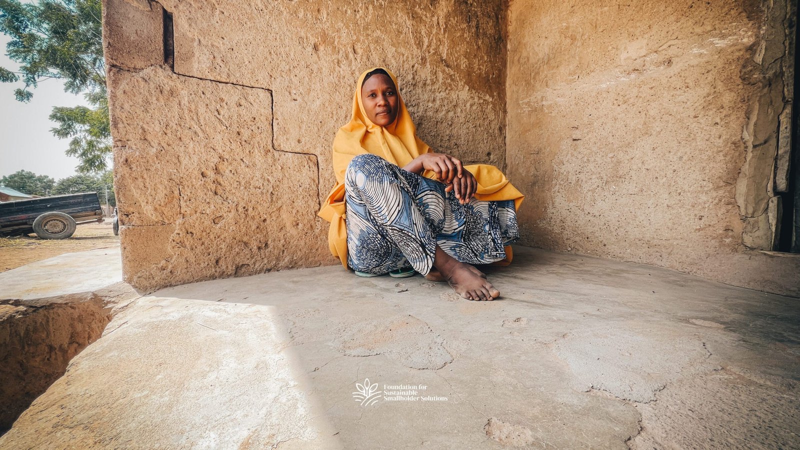 Sekina Danzule sitting in front of her home in Faggo, Shira LGA, Bauchi State.