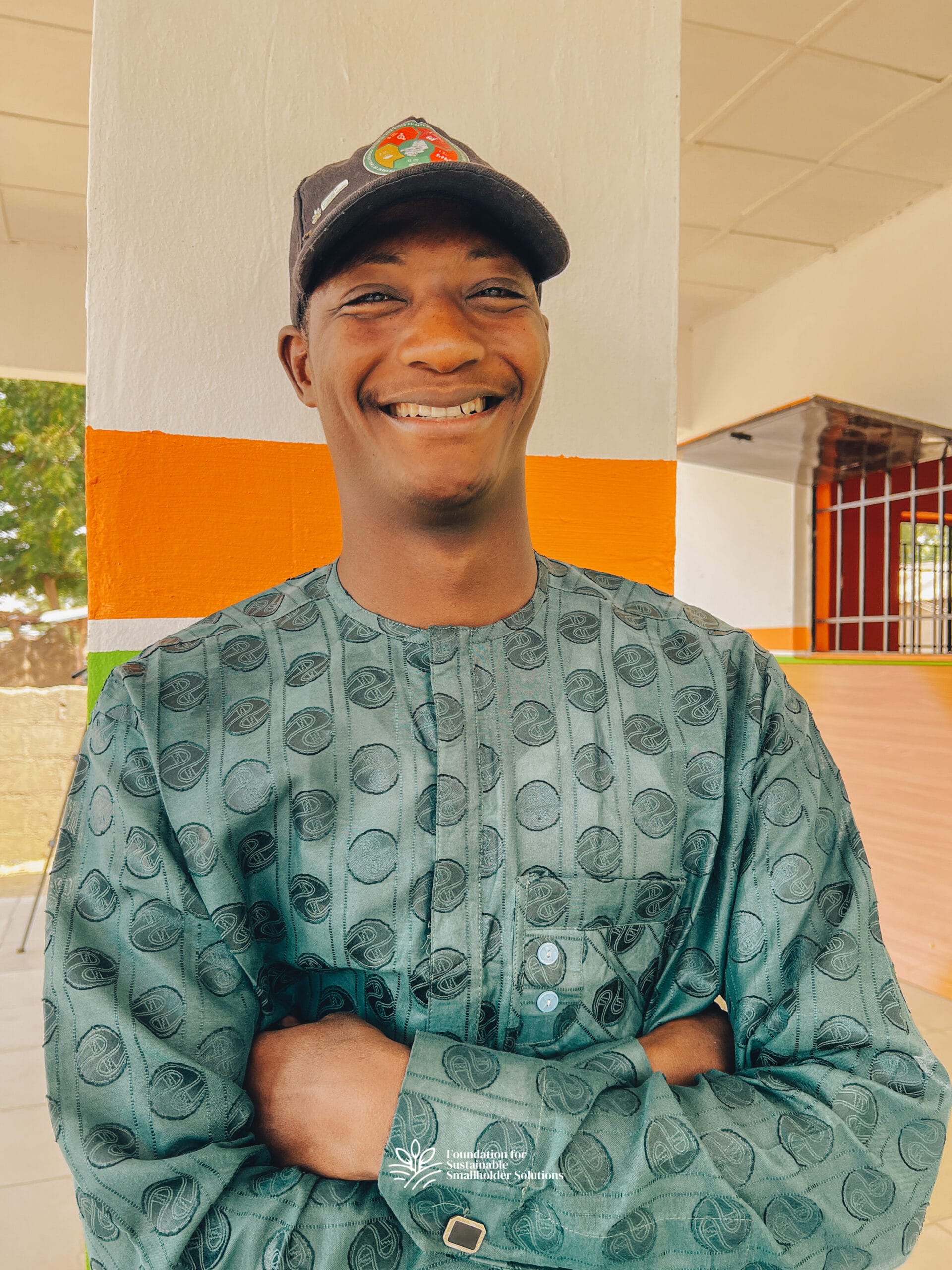 Mohammed Auwal Dahiru smiling with his arms folded across his chest.